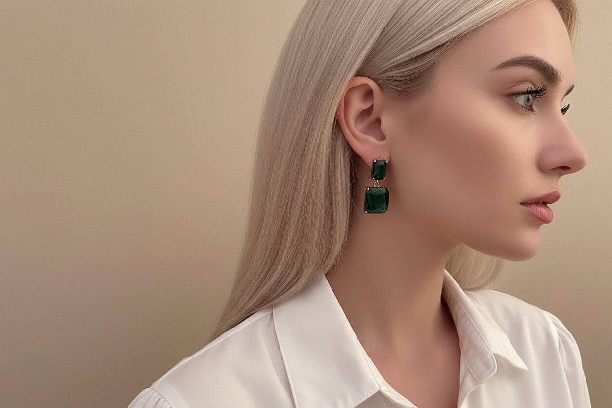 Double emerald-cut green stones in a sleek, minimalist drop design