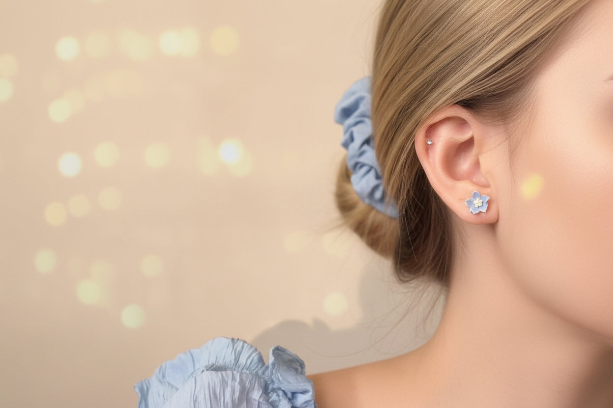 Woman wearing a silver earring with a blurred bokeh background